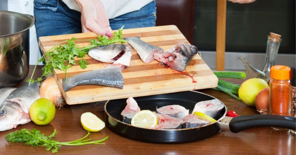 A close-up view of a chef's hands expertly handling and preparing fresh swai fish fillets. The fish glistens under warm, golden lighting, highlighting its delicate texture. In the foreground, the chef deftly seasons the fillets with a blend of aromatic spices, creating a mouthwatering display. The middle ground showcases various cooking techniques, such as searing, baking, and pan-frying, each method demonstrating the versatility of swai fish. The background features a clean, minimalist kitchen setting, allowing the focus to remain on the culinary craftsmanship. The overall scene conveys a sense of mastery and care, inspiring viewers to achieve perfectly cooked swai fish every time. Swai Fish Recipes